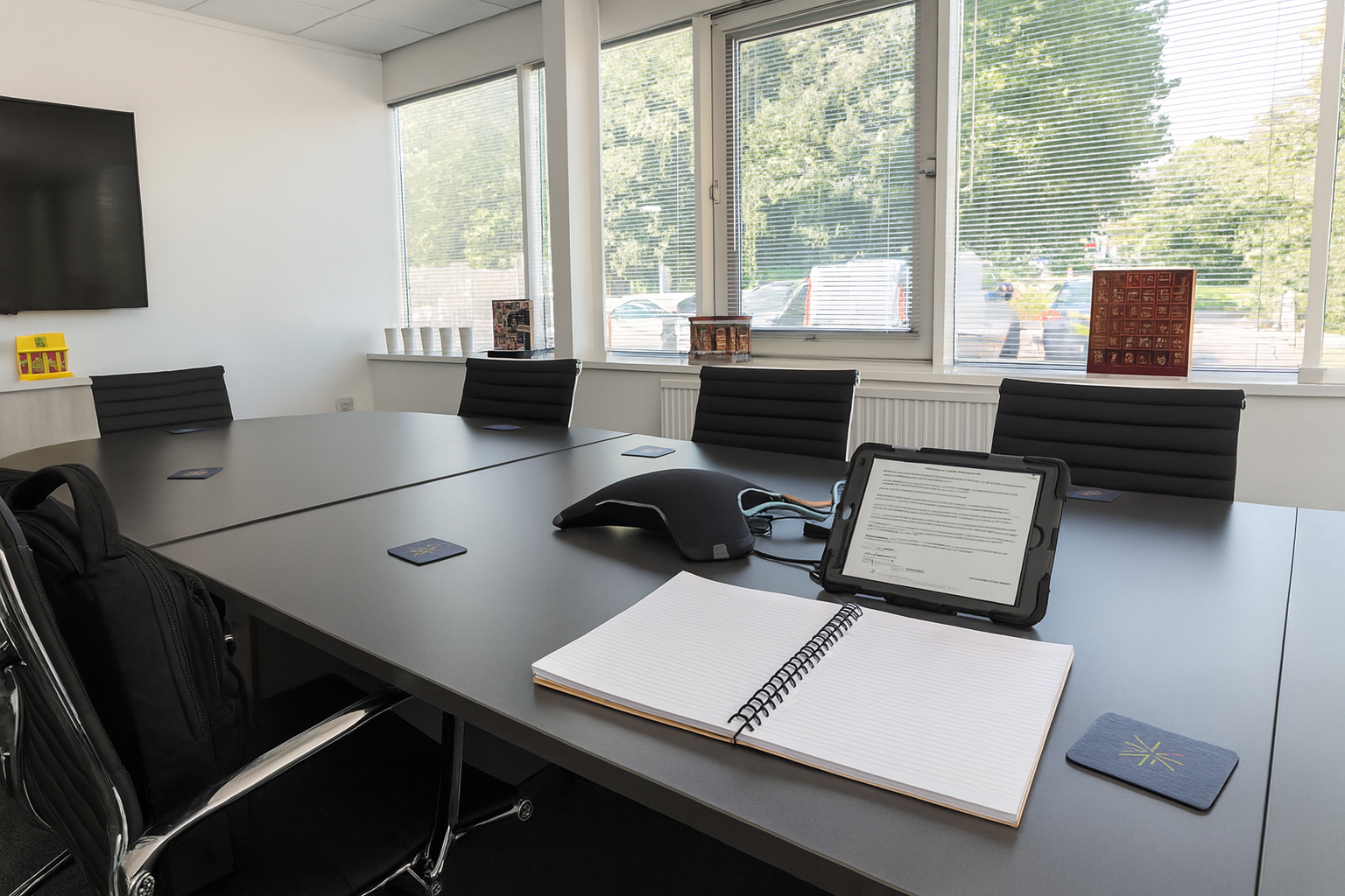 Professional boardroom with meeting table, chairs and screen symbolising a trusted UK health and safety consultant providing competent person services to SMEs.